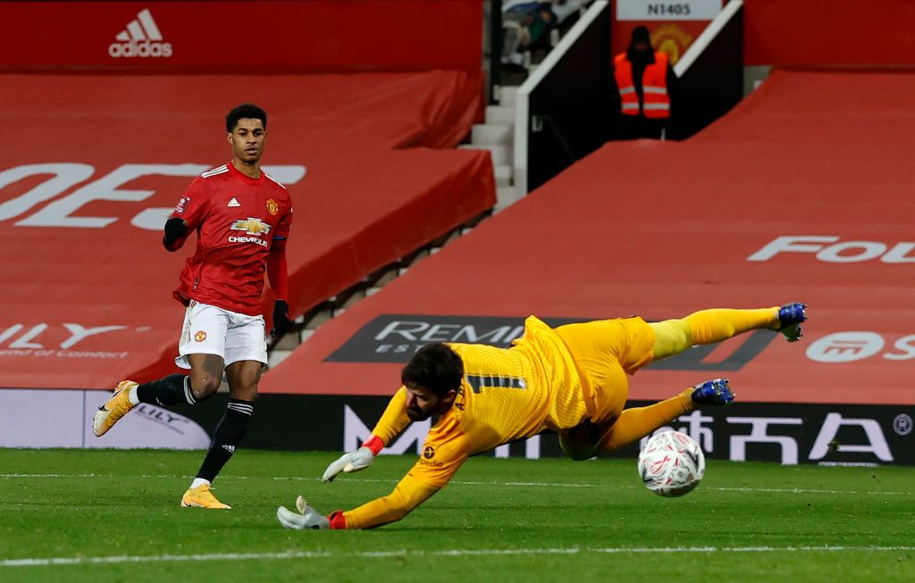 MANCHESTER, ENGLAND - JANUARY 24: Marcus Rashford of Manchester United celebrates after scoring their side's second goal during The Emirates FA Cup Fourth Round match between Manchester United and Liverpool at Old Trafford on January 24, 2021 in Manchester, England. Sporting stadiums around the UK remain under strict restrictions due to the Coronavirus Pandemic as Government social distancing laws prohibit fans inside venues resulting in games being played behind closed doors. (Photo by Martin Rickett - Pool/Getty Images)