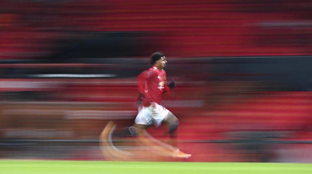 Manchester United's Marcus Rashford races after the ball during the English FA Cup 4th round soccer match between Manchester United and Liverpool at Old Trafford in Manchester, England, Sunday, Jan. 24, 2021. (Laurence Griffiths/Pool via AP)