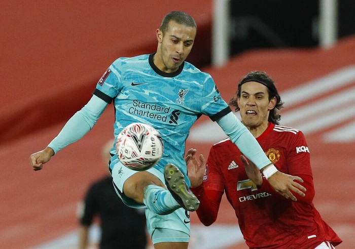 Liverpools Thiago, attempts to control the ball under pressure from Manchester Uniteds Edinson Cavani during the English FA Cup 4th round soccer match between Manchester United and Liverpool at Old Trafford in Manchester, England, Sunday, Jan. 24, 2021. (Phil Noble/Pool via AP)