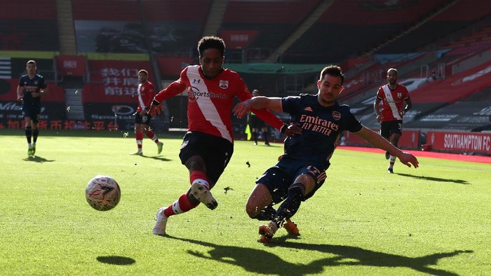 SOUTHAMPTON, ENGLAND - JANUARY 23: Cedric Soares of Arsenal is challenged by Kyle Walker-Peters of Southampton during The Emirates FA Cup Fourth Round match between Southampton FC and Arsenal FC on January 23, 2021 in Southampton, England. Sporting stadiums around the UK remain under strict restrictions due to the Coronavirus Pandemic as Government social distancing laws prohibit fans inside venues resulting in games being played behind closed doors. (Photo by Catherine Ivill/Getty Images)
