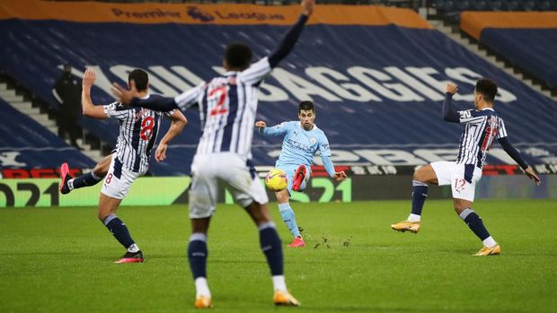 WEST BROMWICH, ENGLAND - JANUARY 26: Joao Cancelo of Manchester City scores their team's second goal during the Premier League match between West Bromwich Albion and Manchester City at The Hawthorns on January 26, 2021 in West Bromwich, England. Sporting stadiums around the UK remain under strict restrictions due to the Coronavirus Pandemic as Government social distancing laws prohibit fans inside venues resulting in games being played behind closed doors. (Photo by Nick Potts - Pool/Getty Images)