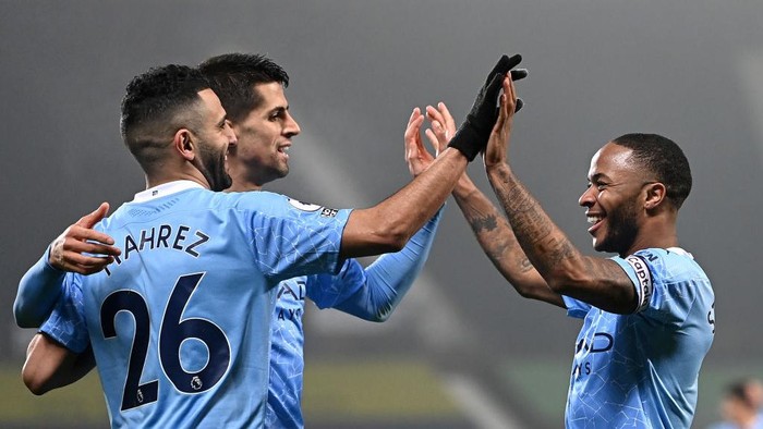 WEST BROMWICH, ENGLAND - JANUARY 26: Raheem Sterling of Manchester City celebrates with Riyad Mahrez and Rodri after scoring their teams fifth goal during the Premier League match between West Bromwich Albion and Manchester City at The Hawthorns on January 26, 2021 in West Bromwich, England. Sporting stadiums around the UK remain under strict restrictions due to the Coronavirus Pandemic as Government social distancing laws prohibit fans inside venues resulting in games being played behind closed doors. (Photo by Laurence Griffiths/Getty Images)