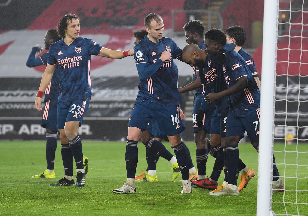 SOUTHAMPTON, ENGLAND - JANUARY 26: Alexandre Lacazette of Arsenal celebrates with Rob Holding and Bukayo Saka after scoring their team's third goal during the Premier League match between Southampton and Arsenal at St Mary's Stadium on January 26, 2021 in Southampton, England. Sporting stadiums around the UK remain under strict restrictions due to the Coronavirus Pandemic as Government social distancing laws prohibit fans inside venues resulting in games being played behind closed doors. (Photo by Andy Rain - Pool/Getty Images)