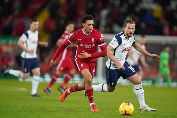 LIVERPOOL, ENGLAND - DECEMBER 16: Trent Alexander-Arnold of Liverpool battles for possession with Harry Kane of Tottenham Hotspur  during the Premier League match between Liverpool and Tottenham Hotspur at Anfield on December 16, 2020 in Liverpool, England. A limited number of fans (2000) are welcomed back to stadiums to watch elite football across England. This was following easing of restrictions on spectators in tiers one and two areas only. (Photo by Jon Super - Pool/Getty Images)