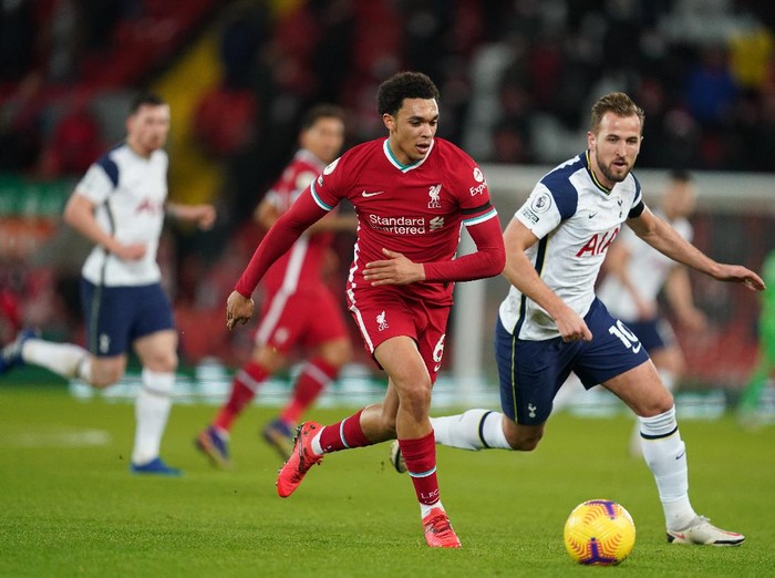 LIVERPOOL, ENGLAND - DECEMBER 16: Trent Alexander-Arnold of Liverpool battles for possession with Harry Kane of Tottenham Hotspur  during the Premier League match between Liverpool and Tottenham Hotspur at Anfield on December 16, 2020 in Liverpool, England. A limited number of fans (2000) are welcomed back to stadiums to watch elite football across England. This was following easing of restrictions on spectators in tiers one and two areas only. (Photo by Jon Super - Pool/Getty Images)
