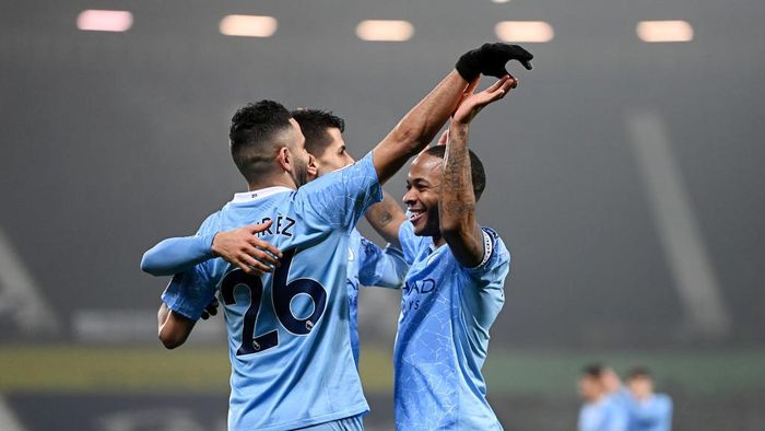 Manchester City WEST BROMWICH, ENGLAND - JANUARY 26: Raheem Sterling of Manchester City celebrates with Riyad Mahrez and Rodri after scoring their teams fifth goal during the Premier League match between West Bromwich Albion and Manchester City at The Hawthorns on January 26, 2021 in West Bromwich, England. Sporting stadiums around the UK remain under strict restrictions due to the Coronavirus Pandemic as Government social distancing laws prohibit fans inside venues resulting in games being played behind closed doors. (Photo by Laurence Griffiths/Getty Images)