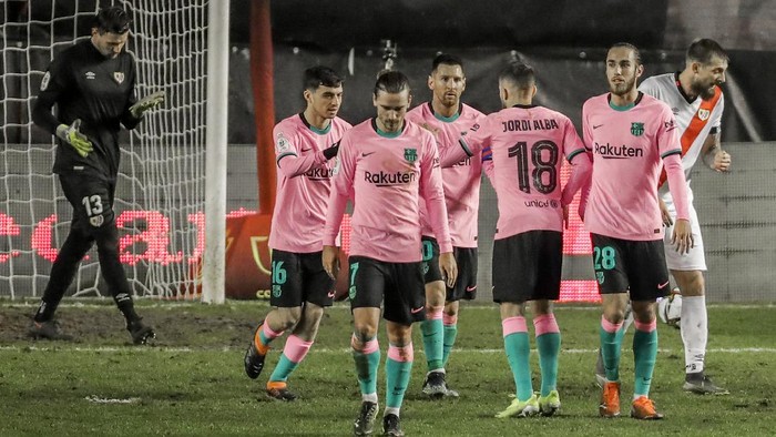 Barcelona players celebrate their first team goal during a Spanish Copa del Rey round of 16 soccer match between Rayo Vallecano and FC Barcelona at the Vallecas stadium in Madrid, Spain, Wednesday, Jan. 27, 2021. (AP Photo/Manu Fernandez)
