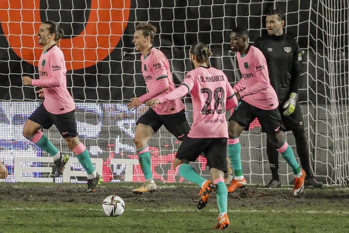 Barcelona players celebrate their second goal during a Spanish Copa del Rey round of 16 soccer match between Rayo Vallecano and FC Barcelona at the Vallecas stadium in Madrid, Spain, Wednesday, Jan. 27, 2021. (AP Photo/Manu Fernandez)