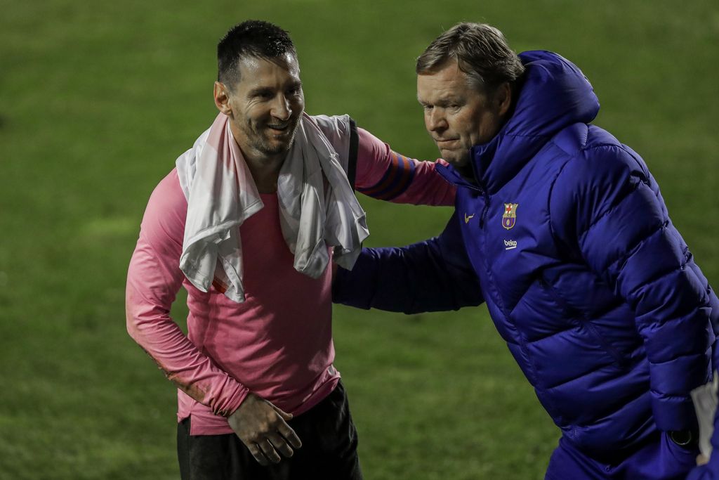 Barcelona's Lionel Messi, left, and Barcelona's head coach Ronald Koeman celebrate after winning a Spanish Copa del Rey round of 16 soccer match against Rayo Vallecano at the Vallecas stadium in Madrid, Spain, Wednesday, Jan. 27, 2021. (AP Photo/Manu Fernandez)