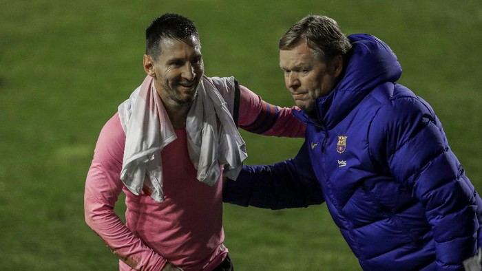 Barcelonas Lionel Messi, left, and Barcelonas head coach Ronald Koeman celebrate after winning a Spanish Copa del Rey round of 16 soccer match against Rayo Vallecano at the Vallecas stadium in Madrid, Spain, Wednesday, Jan. 27, 2021. (AP Photo/Manu Fernandez)