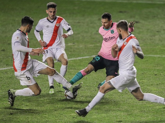 Barcelonas Lionel Messi controls the ball surrounded of Rayo players during a Spanish Copa del Rey round of 16 soccer match between Rayo Vallecano and FC Barcelona at the Vallecas stadium in Madrid, Spain, Wednesday, Jan. 27, 2021. (AP Photo/Manu Fernandez)