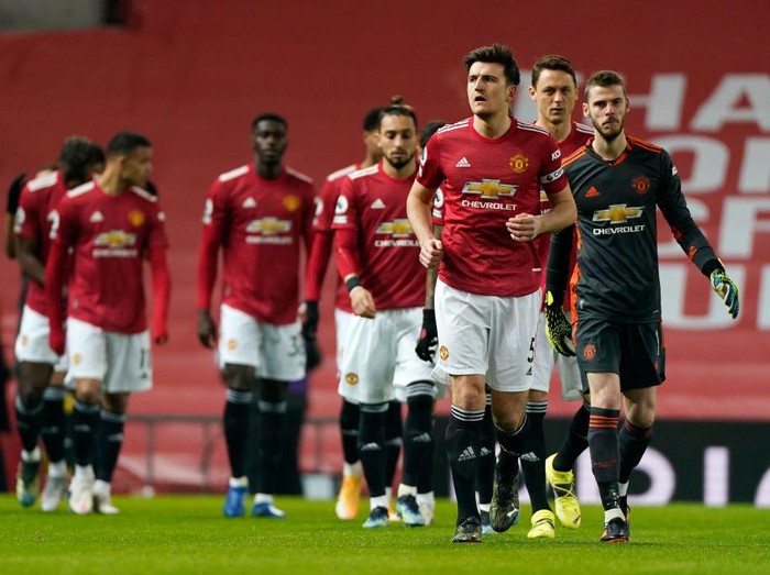 MANCHESTER, ENGLAND - JANUARY 27: Manchester United make their way out onto the pitch lead out by Harry Maguire of Manchester United prior to the Premier League match between Manchester United and Sheffield United at Old Trafford on January 27, 2021 in Manchester, England. Sporting stadiums around the UK remain under strict restrictions due to the Coronavirus Pandemic as Government social distancing laws prohibit fans inside venues resulting in games being played behind closed doors. (Photo by Tim Keeton -