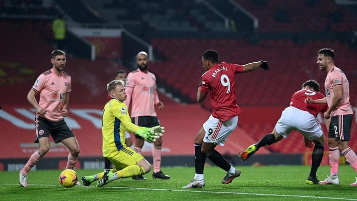 MANCHESTER, ENGLAND - JANUARY 27: Anthony Martial of Manchester United scores a goal which is later disallowed after a foul on Aaron Ramsdale of Sheffield United   during the Premier League match between Manchester United and Sheffield United at Old Trafford on January 27, 2021 in Manchester, England. Sporting stadiums around the UK remain under strict restrictions due to the Coronavirus Pandemic as Government social distancing laws prohibit fans inside venues resulting in games being played behind closed doors. (Photo by Laurence Griffiths/Getty Images)