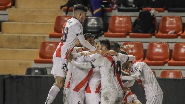 Rayo players celebrate after scoring the opening goal during a Spanish Copa del Rey round of 16 soccer match between Rayo Vallecano and FC Barcelona at the Vallecas stadium in Madrid, Spain, Wednesday, Jan. 27, 2021. (AP Photo/Manu Fernandez)