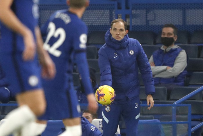 Chelseas new head coach Thomas Tuchel holds the ball during the English Premier League soccer match between Chelsea and Wolverhampton Wanderers at Stamford Bridge Stadium in London, England, Wednesday, Jan. 27, 2021. (AP Photo/Frank Augstein)