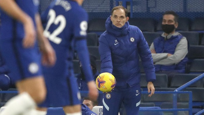 Chelseas new head coach Thomas Tuchel holds the ball during the English Premier League soccer match between Chelsea and Wolverhampton Wanderers at Stamford Bridge Stadium in London, England, Wednesday, Jan. 27, 2021. (AP Photo/Frank Augstein)