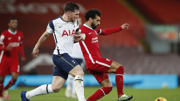 LIVERPOOL, ENGLAND - DECEMBER 16: Mohamed Salah of Liverpool passes the ball under pressure from Pierre-Emile Hoejbjerg of Tottenham Hotspur during the Premier League match between Liverpool and Tottenham Hotspur at Anfield on December 16, 2020 in Liverpool, England. A limited number of fans (2000) are welcomed back to stadiums to watch elite football across England. This was following easing of restrictions on spectators in tiers one and two areas only. (Photo by Clive Brunskill/Getty Images)