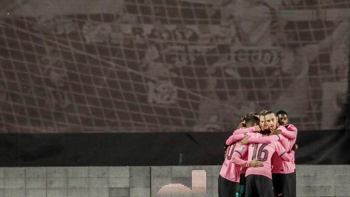 Barcelona players celebrate their second goal during a Spanish Copa del Rey round of 16 soccer match between Rayo Vallecano and FC Barcelona at the Vallecas stadium in Madrid, Spain, Wednesday, Jan. 27, 2021. (AP Photo/Manu Fernandez)