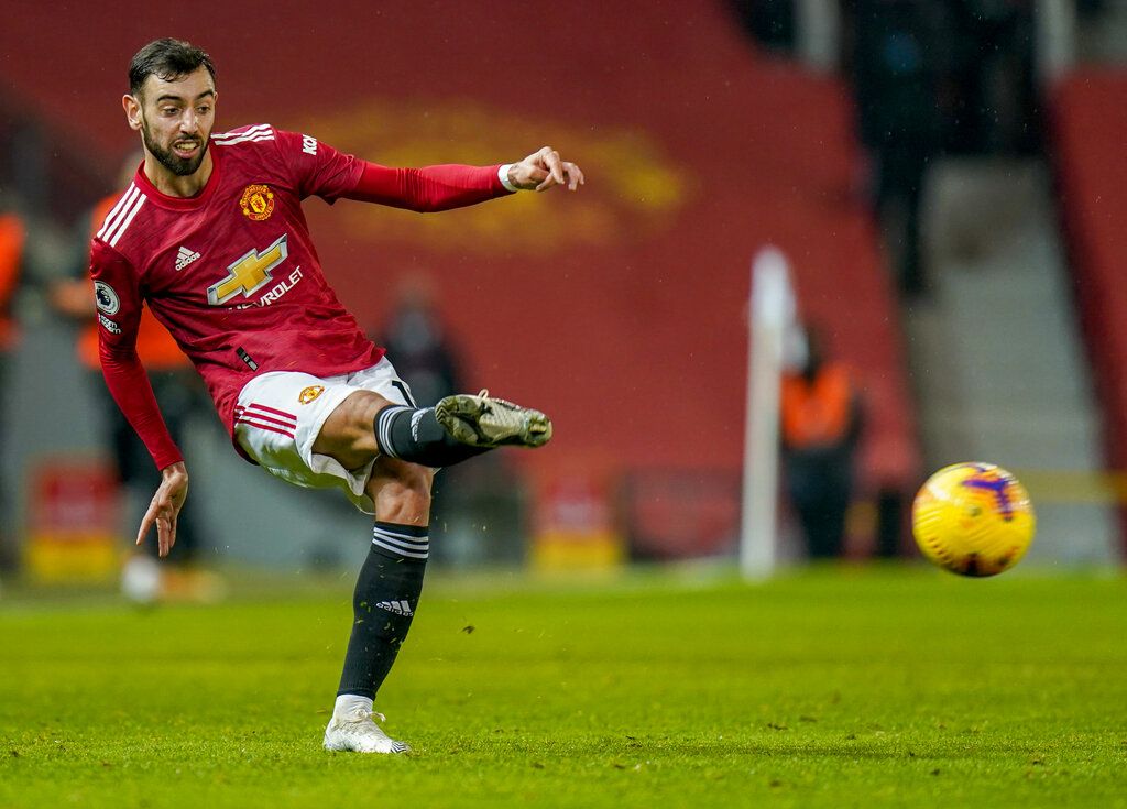 Manchester United's Bruno Fernandes kicks the ball during the English Premier League soccer match between Manchester United and Sheffield United at Old Trafford, Manchester, England, Wednesday, Jan. 27, 2021. (AP Photo/Tim Keeton,Pool)