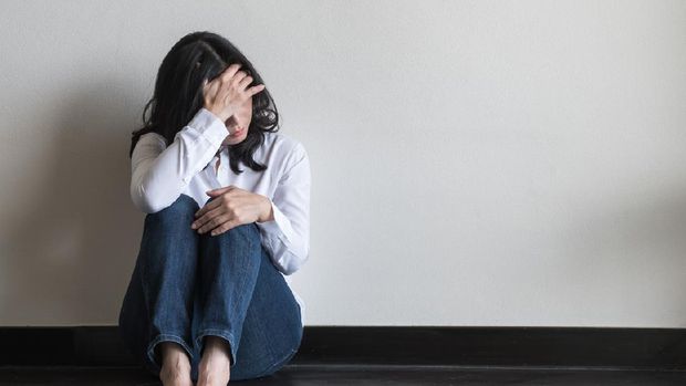 Anxiety disorder menopause woman, stressful depressed, panic attack person with mental health illness, headache and migraine sitting with back against wall on the floor in domestic home