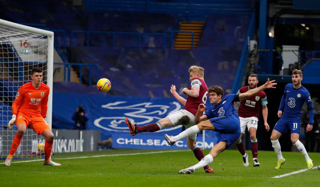 LONDON, ENGLAND - JANUARY 31: Marcos Alonso of Chelsea scores their side's second goal past Nick Pope of Burnley during the Premier League match between Chelsea and Burnley at Stamford Bridge on January 31, 2021 in London, England. Sporting stadiums around the UK remain under strict restrictions due to the Coronavirus Pandemic as Government social distancing laws prohibit fans inside venues resulting in games being played behind closed doors. (Photo by Andrew Couldridge - Pool/Getty Images)
