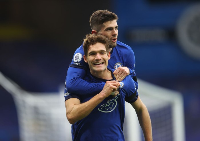 LONDON, ENGLAND - JANUARY 31: Marcos Alonso of Chelsea celebrates with team mate Christian Pulisic after scoring their sides second goal during the Premier League match between Chelsea and Burnley at Stamford Bridge on January 31, 2021 in London, England. Sporting stadiums around the UK remain under strict restrictions due to the Coronavirus Pandemic as Government social distancing laws prohibit fans inside venues resulting in games being played behind closed doors. (Photo by Julian Finney/Getty Images)