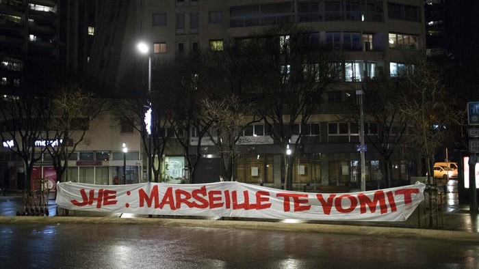 A woman walks by the velodrome stadium in Marseille, southern France, Saturday Jan. 30, 2021.The French league postponed Marseilles home game against Rennes just three hours before kickoff on Saturday after angry Marseille fans marched to the clubs training complex to protest poor results. (AP Photo/Daniel Cole)