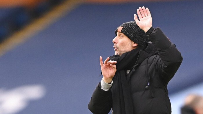 Manchester Citys head coach Pep Guardiola reacts during the English Premier League match between Manchester City and Sheffield United at the the City of Manchester Stadium in Manchester, England, Saturday, Jan. 30, 2021. (Laurence Griffiths/Pool via AP)