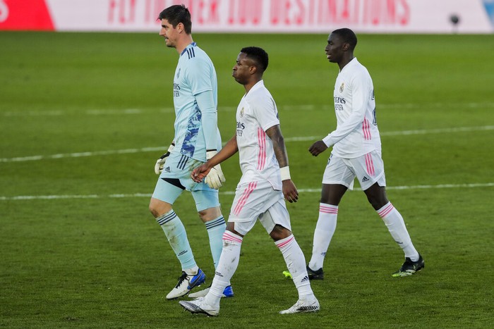 From left to right: Real Madrids goalkeeper Thibaut Courtois, Vinicius Junior and Ferland Mendy leave the pitch after the Spanish La Liga soccer match between Real Madrid and Levante at the Alfredo Di Stefano stadium in Madrid, Spain, Saturday, Jan. 30, 2021. (AP Photo/Manu Fernandez)