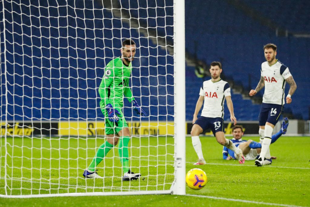 BRIGHTON, ENGLAND - JANUARY 31: Leandro Trossard of Brighton & Hove Albion scores their side's first goal past Hugo Lloris of Tottenham Hotspur whilst under pressure from Ben Davies and Toby Alderweireld of Tottenham Hotspur during the Premier League match between Brighton & Hove Albion and Tottenham Hotspur at American Express Community Stadium on January 31, 2021 in Brighton, England. Sporting stadiums around the UK remain under strict restrictions due to the Coronavirus Pandemic as Government social distancing laws prohibit fans inside venues resulting in games being played behind closed doors. (Photo by Mike Hewitt/Getty Images)