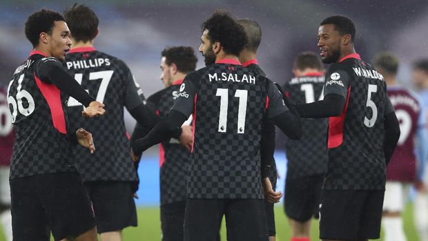 Liverpool's Mohamed Salah, center, celebrates after scoring his side's opening goal during the English Premier League match between West Ham and Liverpool at the the London Stadium in London, Sunday, Jan. 31, 2021. (Clive Rose/Pool via AP)