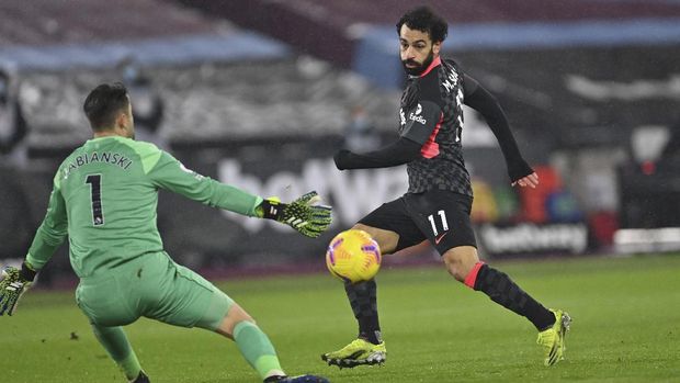 Liverpool's Mohamed Salah scores his side's second goal during the English Premier League match between West Ham and Liverpool at the the London Stadium in London, Sunday, Jan. 31, 2021. (Justin Setterfield/Pool via AP)