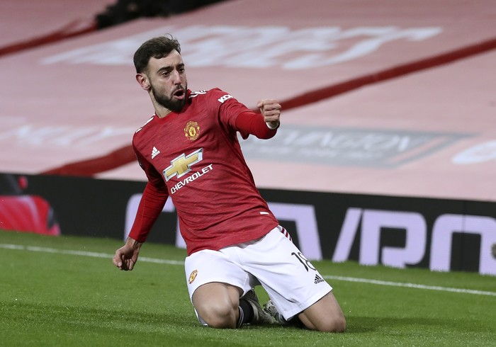 Manchester Uniteds Bruno Fernandes celebrates after scoring his sides third goal during the English FA Cup 4th round soccer match between Manchester United and Liverpool at Old Trafford in Manchester, England, Sunday, Jan. 24, 2021. (Martin Rickett/Pool via AP)