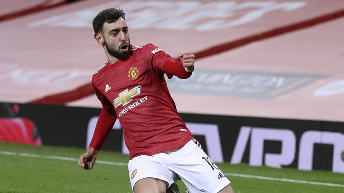 Manchester Uniteds Bruno Fernandes celebrates after scoring his sides third goal during the English FA Cup 4th round soccer match between Manchester United and Liverpool at Old Trafford in Manchester, England, Sunday, Jan. 24, 2021. (Martin Rickett/Pool via AP)
