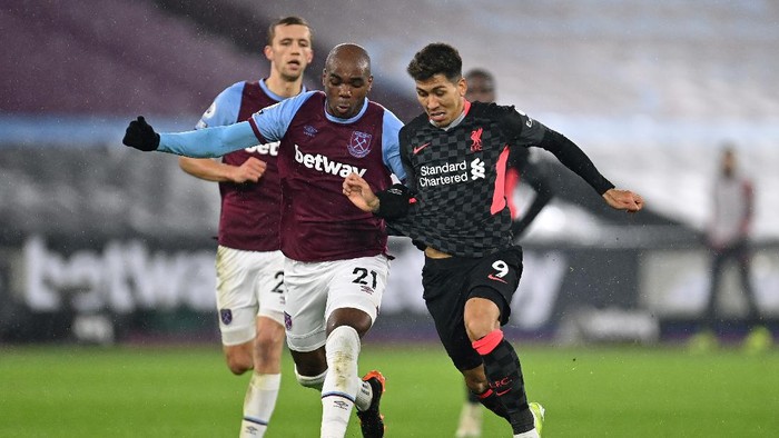 LONDON, ENGLAND - JANUARY 31: Roberto Firmino of Liverpool and Angelo Ogbonna of West Ham United compete for thw baLL during the Premier League match between West Ham United and Liverpool at London Stadium on January 31, 2021 in London, England. Sporting stadiums around the UK remain under strict restrictions due to the Coronavirus Pandemic as Government social distancing laws prohibit fans inside venues resulting in games being played behind closed doors. (Photo by Justin Setterfield/Getty Images)