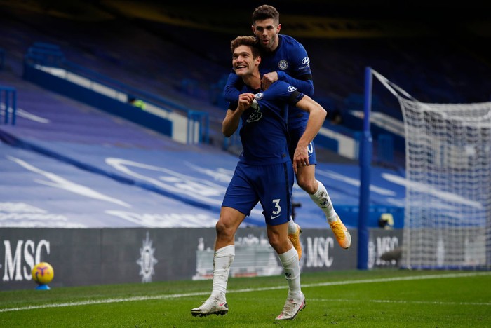 LONDON, ENGLAND - JANUARY 31: Marcos Alonso of Chelsea celebrates with team mate Christian Pulisic after scoring their sides second goal during the Premier League match between Chelsea and Burnley at Stamford Bridge on January 31, 2021 in London, England. Sporting stadiums around the UK remain under strict restrictions due to the Coronavirus Pandemic as Government social distancing laws prohibit fans inside venues resulting in games being played behind closed doors. (Photo by Andrew Couldridge - Pool/Getty Images)