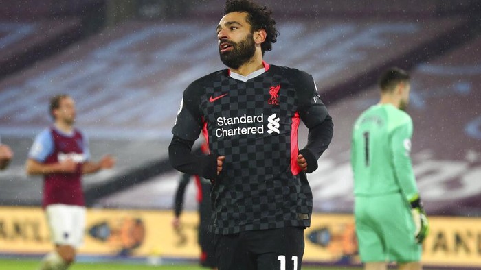 Liverpools Mohamed Salah celebrates after scoring his sides second goal during the English Premier League match between West Ham and Liverpool at the the London Stadium in London, Sunday, Jan. 31, 2021. (Clive Rose/Pool via AP)