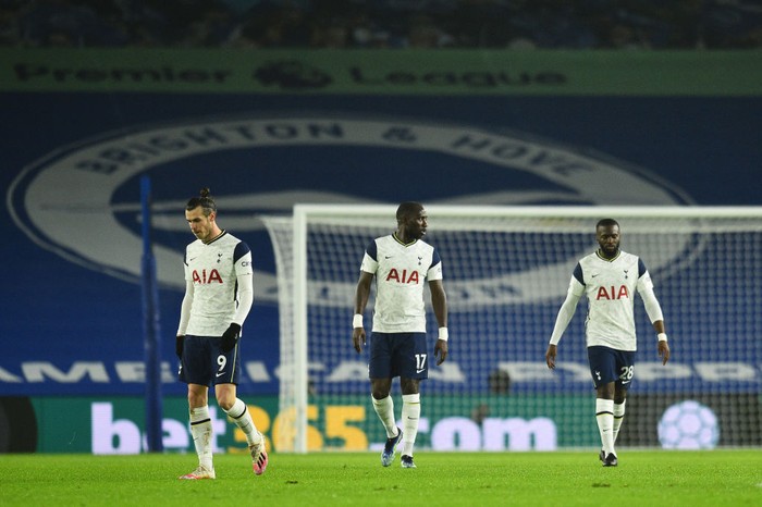 BRIGHTON, ENGLAND - JANUARY 31: (L - R) Gareth Bale, Moussa Sissoko and Tanguy Ndombele of Tottenham Hotspur look dejected after Brightons first goal scored by Leandro Trossard (Not pictured) during the Premier League match between Brighton & Hove Albion and Tottenham Hotspur at American Express Community Stadium on January 31, 2021 in Brighton, England. Sporting stadiums around the UK remain under strict restrictions due to the Coronavirus Pandemic as Government social distancing laws prohibit fans inside venues resulting in games being played behind closed doors. (Photo by Glyn Kirk - Pool/Getty Images)
