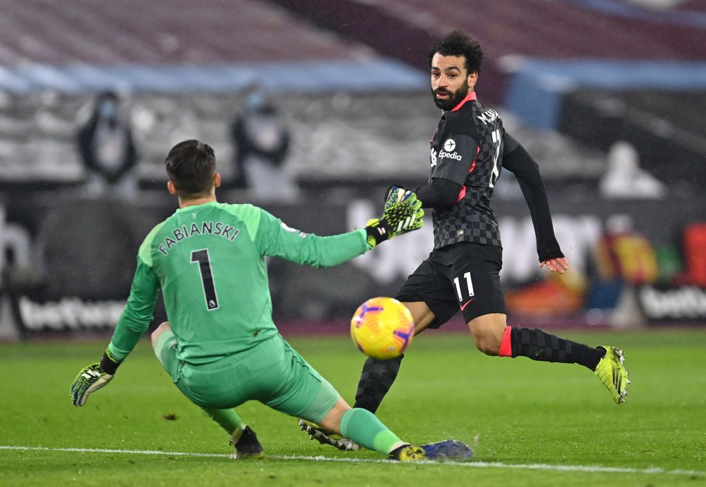 LONDON, ENGLAND - JANUARY 31: Mohamed Salah of Liverpool scores their side's second goal past Lukasz Fabianski of West Ham United during the Premier League match between West Ham United and Liverpool at London Stadium on January 31, 2021 in London, England. Sporting stadiums around the UK remain under strict restrictions due to the Coronavirus Pandemic as Government social distancing laws prohibit fans inside venues resulting in games being played behind closed doors. (Photo by Justin Setterfield/Getty Images)