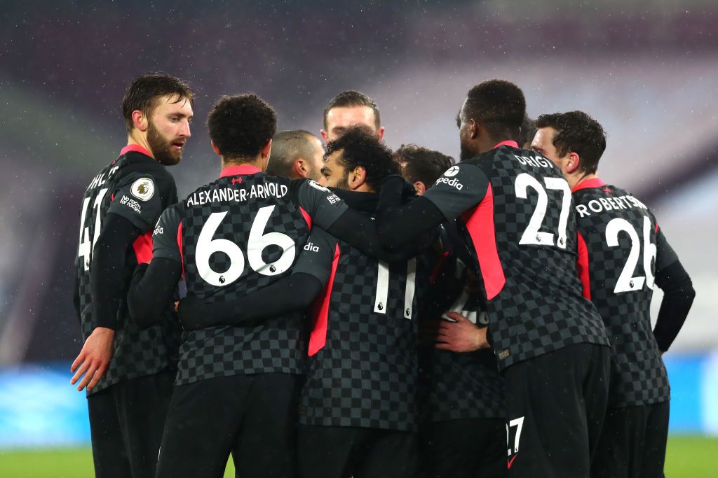 LONDON, ENGLAND - JANUARY 31: Mohamed Salah of Liverpool celebrates with Nathaniel Phillips (L) and team mates after scoring their side's first goal during the Premier League match between West Ham United and Liverpool at London Stadium on January 31, 2021 in London, England. Sporting stadiums around the UK remain under strict restrictions due to the Coronavirus Pandemic as Government social distancing laws prohibit fans inside venues resulting in games being played behind closed doors. (Photo by Clive Rose/Getty Images)