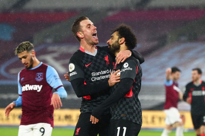 LONDON, ENGLAND - JANUARY 31: Mohamed Salah of Liverpool celebrates with teammate Jordan Henderson after scoring their sides second goal during the Premier League match between West Ham United and Liverpool at London Stadium on January 31, 2021 in London, England. Sporting stadiums around the UK remain under strict restrictions due to the Coronavirus Pandemic as Government social distancing laws prohibit fans inside venues resulting in games being played behind closed doors. (Photo by Clive Rose/Getty Images)