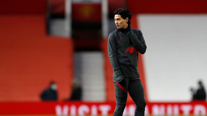 MANCHESTER, ENGLAND - JANUARY 24: Takumi Minamino of Liverpool warms up ahead of The Emirates FA Cup Fourth Round match between Manchester United and Liverpool at Old Trafford on January 24, 2021 in Manchester, England. Sporting stadiums around the UK remain under strict restrictions due to the Coronavirus Pandemic as Government social distancing laws prohibit fans inside venues resulting in games being played behind closed doors. (Photo by Phil Noble - Pool/Getty Images)