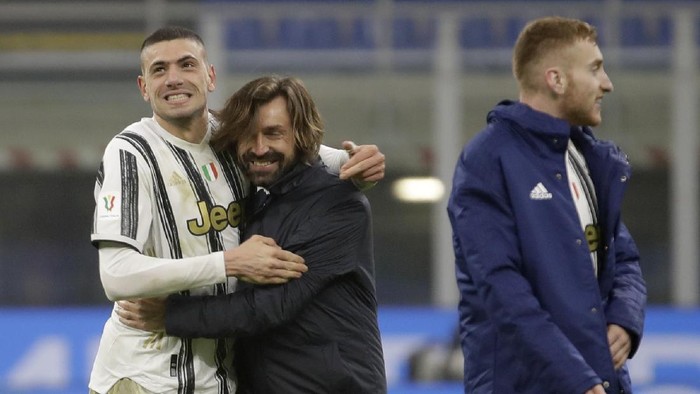 Juventus head coach Andrea Pirlo hugs Merih Demiral after the Italian Cup semi-final first leg soccer match between Inter Milan and Juventus at the San Siro stadium, in Milan, Italy, Tuesday, Feb. 2, 2021. Juventus won 2-1. (AP Photo/Luca Bruno)