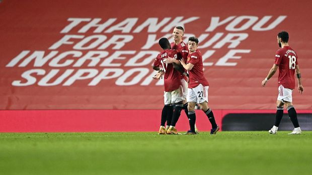 Manchester United's Scott McTominay celebrates with teammates after scoring his side's sixth goal during the English Premier League soccer match between Manchester United and Southampton, at the Old Trafford stadium in Manchester, England, Tuesday, Feb. 2, 2021. (Laurence Griffiths/Pool via AP)