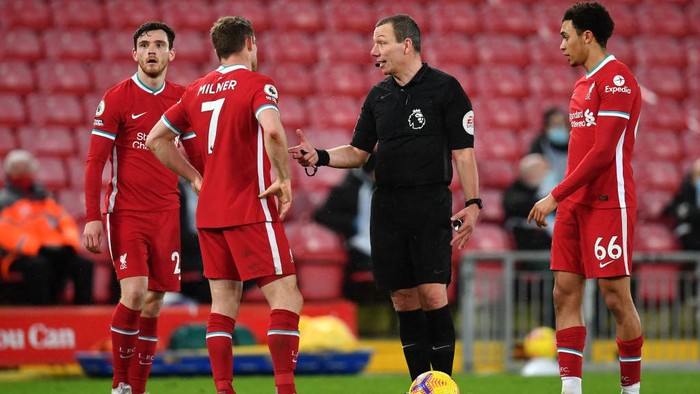 LIVERPOOL, ENGLAND - FEBRUARY 03: Andy Robertson, James Milner and Trent Alexander-Arnold of Liverpool speak with Referee Kevin Friend during the Premier League match between Liverpool and Brighton & Hove Albion at Anfield on February 03, 2021 in Liverpool, England. Sporting stadiums around the UK remain under strict restrictions due to the Coronavirus Pandemic as Government social distancing laws prohibit fans inside venues resulting in games being played behind closed doors. (Photo by Paul Ellis - Pool/Getty Images)