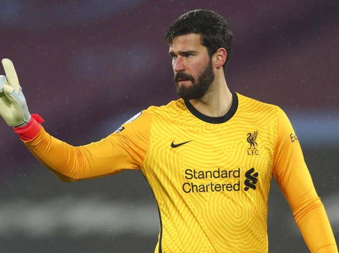Liverpool's goalkeeper Alisson reacts during the English Premier League match between West Ham and Liverpool at the the London Stadium in London, Sunday, Jan. 31, 2021. (Clive Rose/Pool via AP)