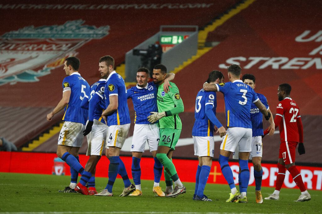 Brighton players celebrate at the end of the English Premier League soccer match between Liverpool and Brighton at Anfield stadium, in Liverpool, England, Wednesday, Feb. 3, 2021. Brighton won 1-0. (Phil Noble/Pool via AP)