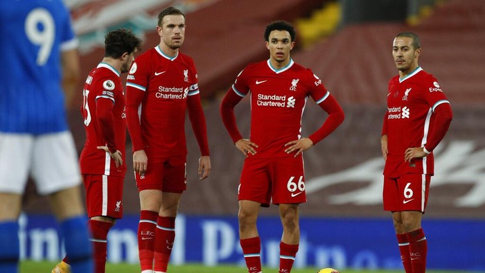 Liverpool players stand after Brightons Steven Alzate scored his sides first goal during the English Premier League soccer match between Liverpool and Brighton at Anfield stadium, in Liverpool, England, Wednesday, Feb. 3, 2021. (Phil Noble/Pool via AP)