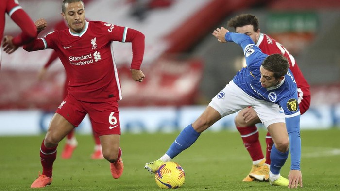 Brightons Leandro Trossard, right, challenges for the ball with Liverpools Thiago during the English Premier League soccer match between Liverpool and Brighton at Anfield stadium, in Liverpool, England, Wednesday, Feb. 3, 2021.(Clive Brunskill/Pool via AP)