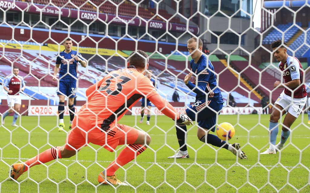 Aston Villa's Ollie Watkins, right, scores his side's opening goal during the English Premier League soccer match between Aston Villa and Arsenal at Villa Park in Birmingham, England, Saturday, Feb. 6, 2021. (Nick Potts, Pool via AP)